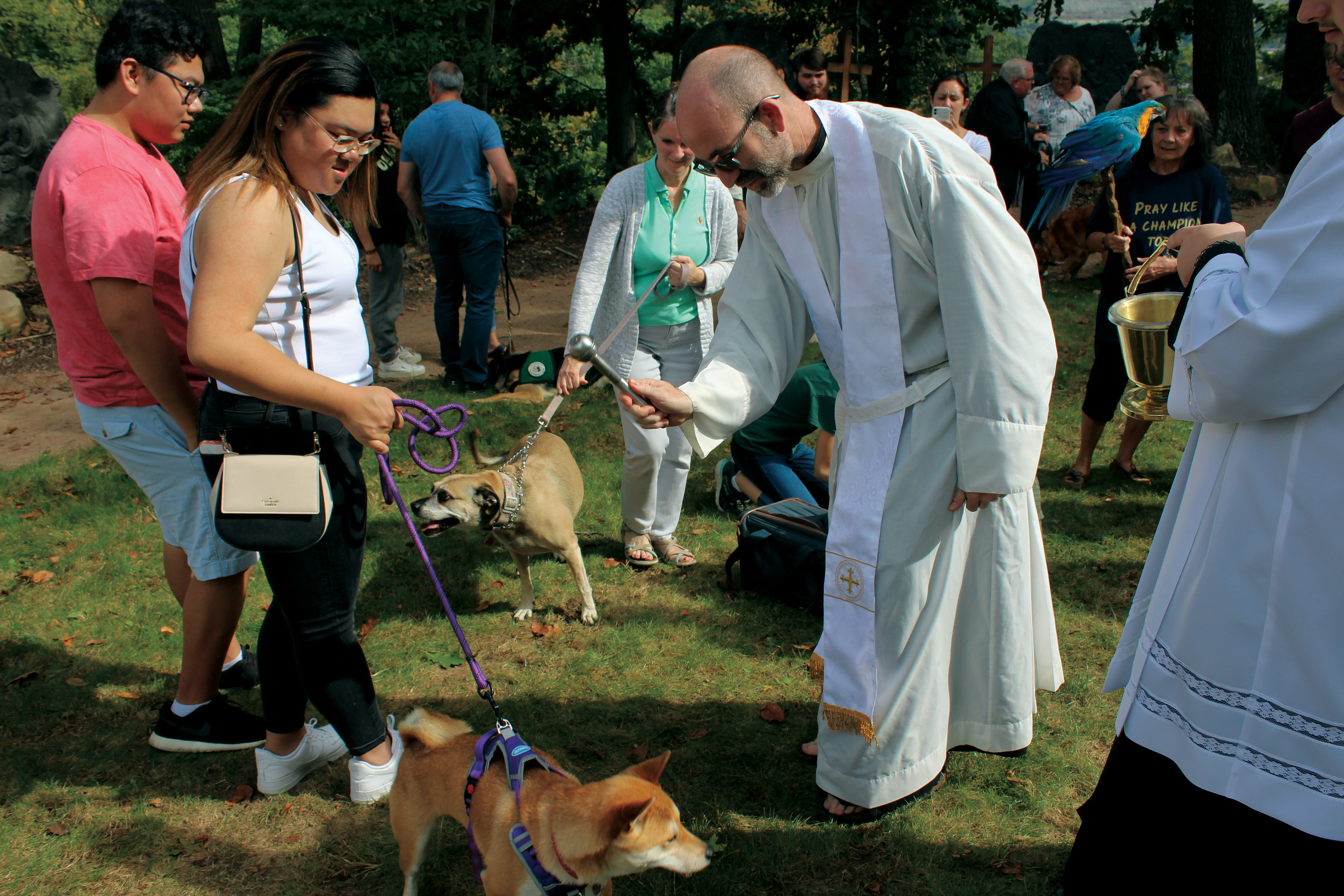 Fr. Jonathan St. André, TOR, blessing pets during homecoming.