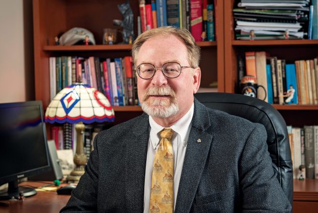 Dr. Daniel Kempton sitting at his desk.