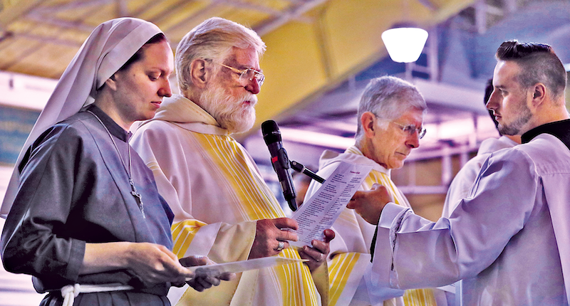 Sr. Chiara JoanRiffon, TOR, hall chaplain; Fr. Stanley Holland, TOR ’82, pastoral associate; and Fr. James Angert, TOR, pastoral associate, take the Oath of Fidelity.