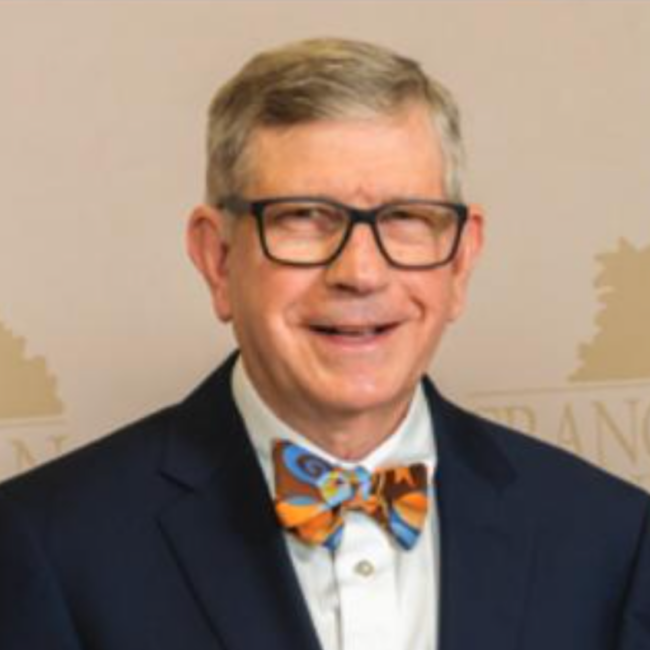 Headshot of Professor Joe Zoric, in a suit, bowtie, and glasses.