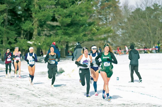 Women runners racing in the snow.