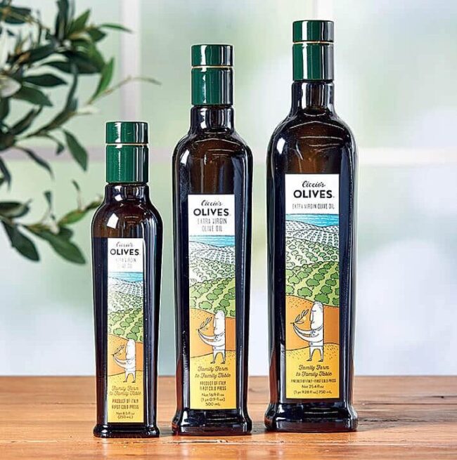 Three bottles of olive oil going from smallest to largest.