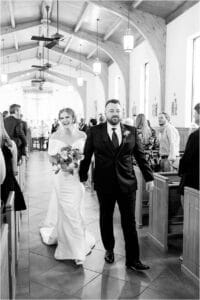 Nicole Rewerts ’21 MA ’24 exiting St. Philip Neri Catholic Church in Mobile, Ala., with her new husband, Anthony Scott