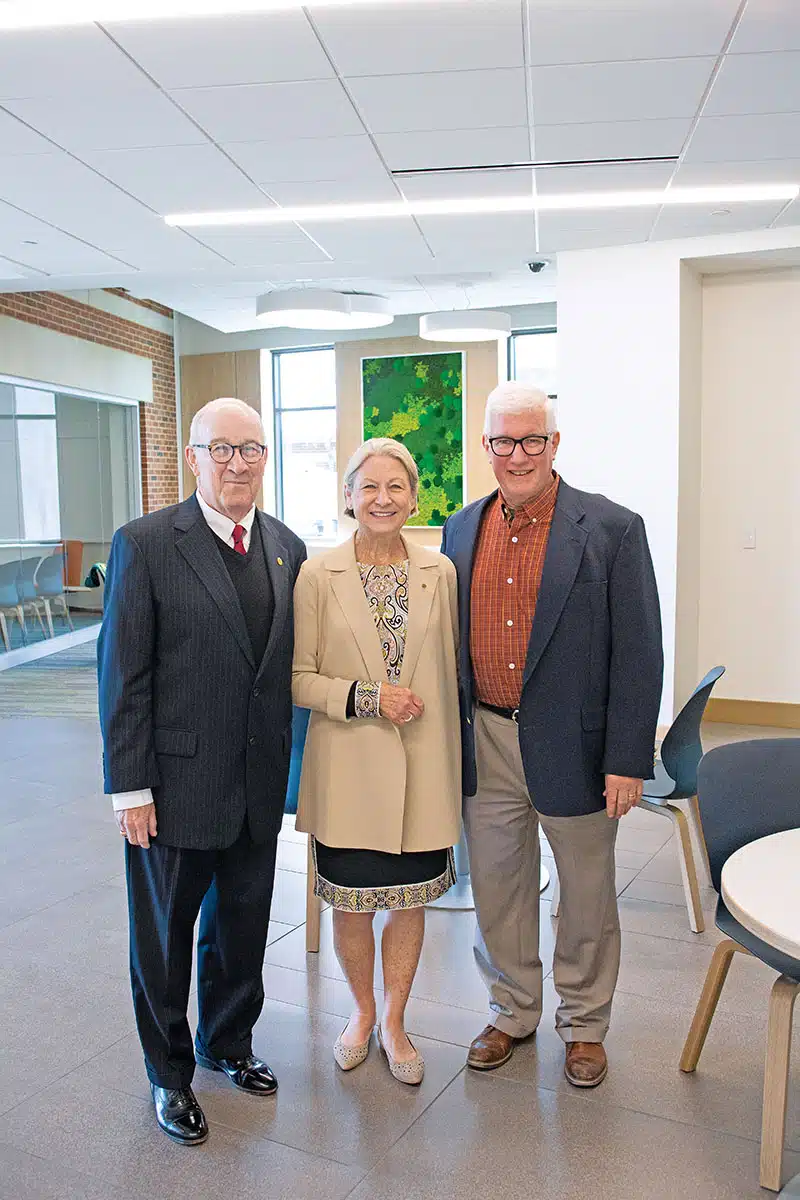 Mickey and Kaya Pohl tour Christ the Teacher Hall with Joe McGurn, retired executive director of Franciscan’s Physical Plant Services.