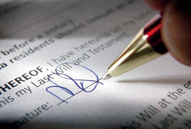 A closeup of a pen signing a contract.