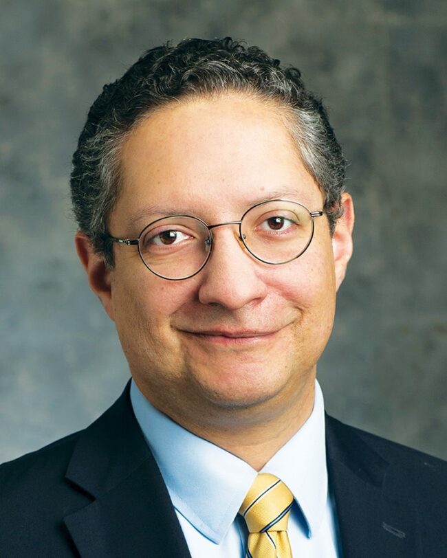 Deacon Omar Gutiérrez with a gray background.