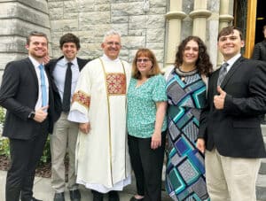 Joseph Assaf with his family in front of a church during Joseph's ordination to the the diaconate.