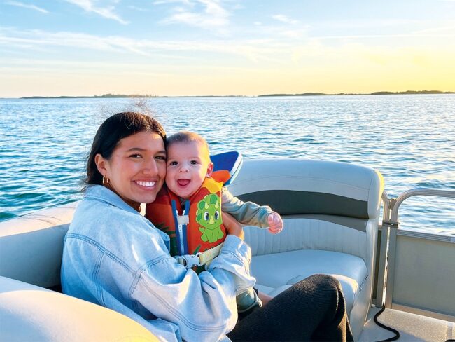 Mariana Kuhlman holding her son Raphael Patrick on a boat.