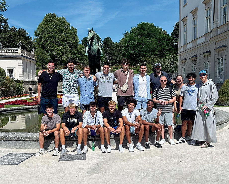 The Barons men’s basketball team in front of a horse statue when they visited Austria.