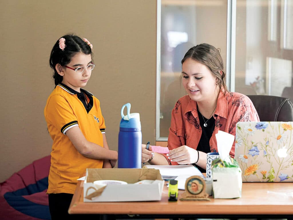 Lizzie Amland teaching a young student in Erbil Iraq.