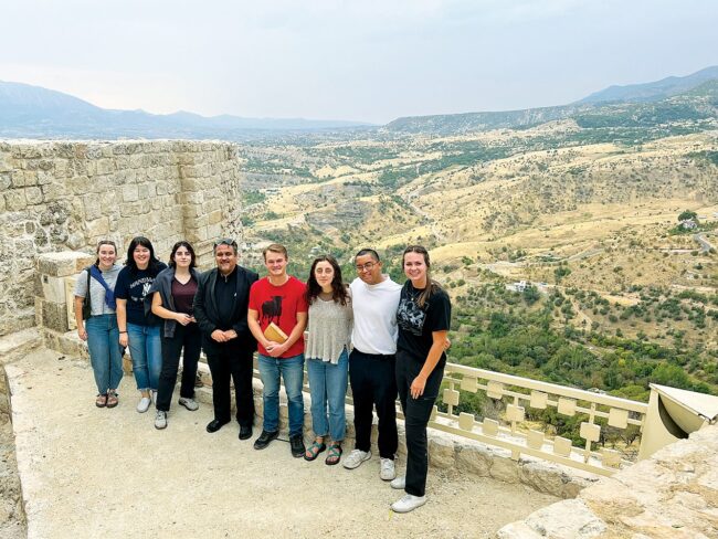Missionaries Anne Mosier, Margaret Wittmann, Rosemary Prezzia, Fr. Samir Putros Yousif, Alex McKenna, Colette Allen, and Lizzie Amland at one of the ancient gates leading into the mountain city of Amedi.