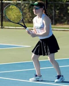 Claire Cardie playing tennis in the sun. 
