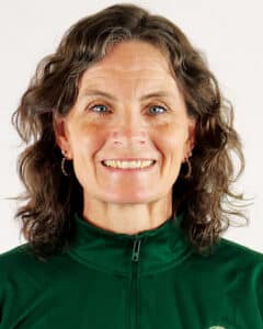Coach Jennifer Hickey wearing a green zip-up on a white background.