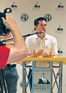 Dan Vansteenburg ’93 in a polo shirt at a press conference for the expansion of Franciscan Square.