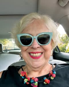 Elinor Mattern in sunglasses sitting in a car. 