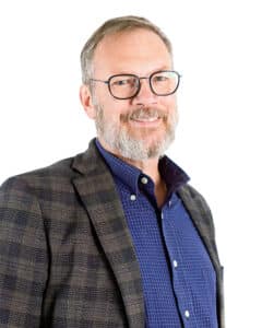John McCormick in professional wear in front of a white background.