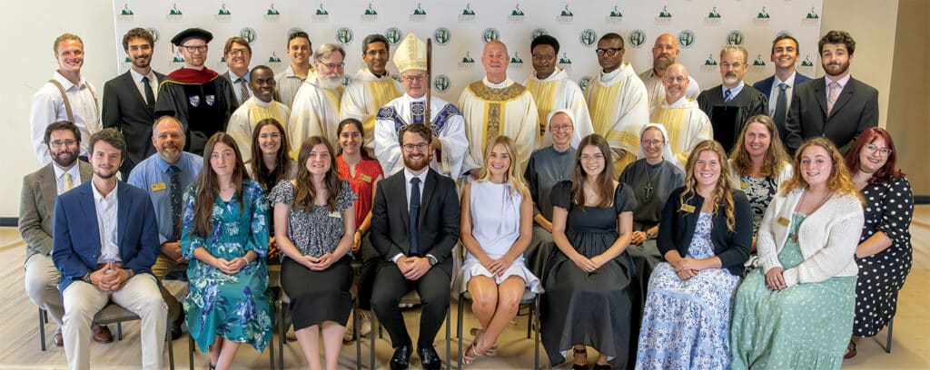 A group photo of faculty from the Franciscan University of Steubenville and priest and the bishop after taking the Oath of Fidelity.