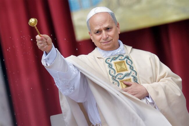 Pope Leo XIV sprinkling holy water.