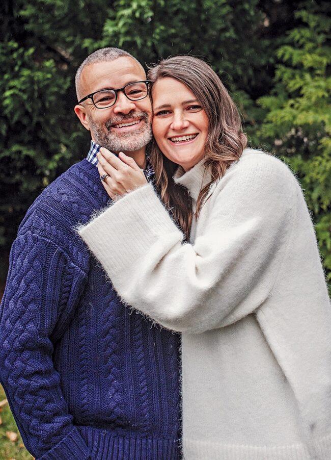 Portrait of a married couple smiling together outdoors, wearing sweaters, photographed for a Franciscan magazine alumni feature.