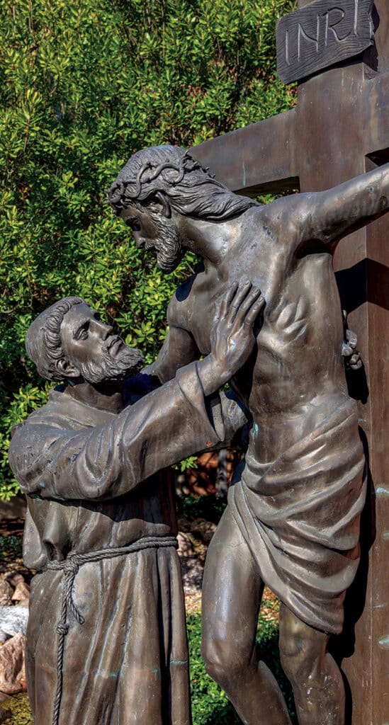 Bronze statue of St. Francis with the crucified Christ