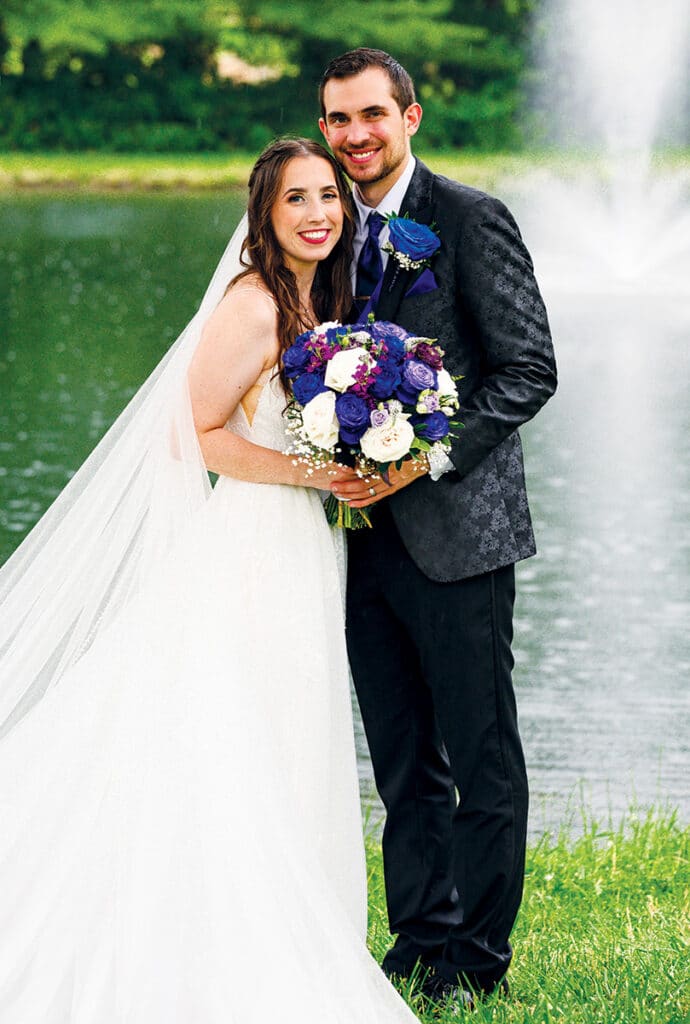 Brooklynn Miller and Maxwell Snow posing for an outdoor wedding photo.