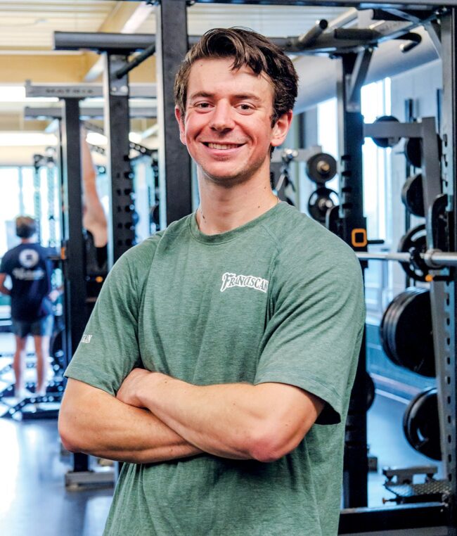 Portrait of Curt McGovern standing in a gym.