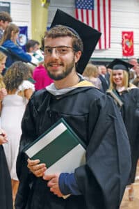 A graduate holding his diploma.