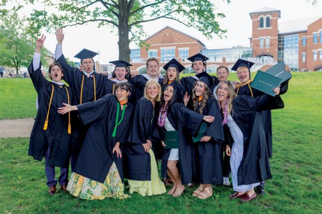 Franciscan University Class of 2026 graduates celebrating outdoors on campus after commencement.