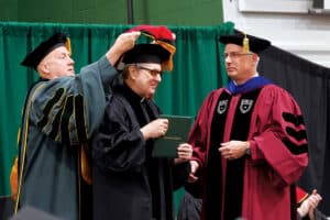 Fr. Dave Pivonka and Dr. Hildebrand assisting Fr. Robert Spitzer, SJ, during a Franciscan University commencement ceremony.