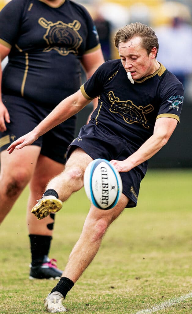 Joe Bob Moleski kicking a rugby ball during a Franciscan University rugby match.