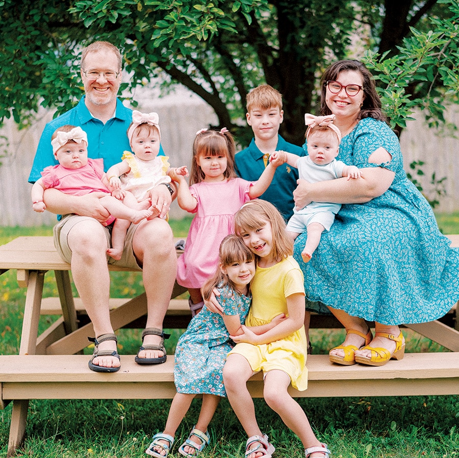 Family of Joseph ’12 and Yvonne (Peredo ’11) Hess posing together outdoors for a group portrait.