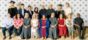 Franciscan University group portrait with faculty, staff, clergy, religious sisters, and graduates in academic attire.